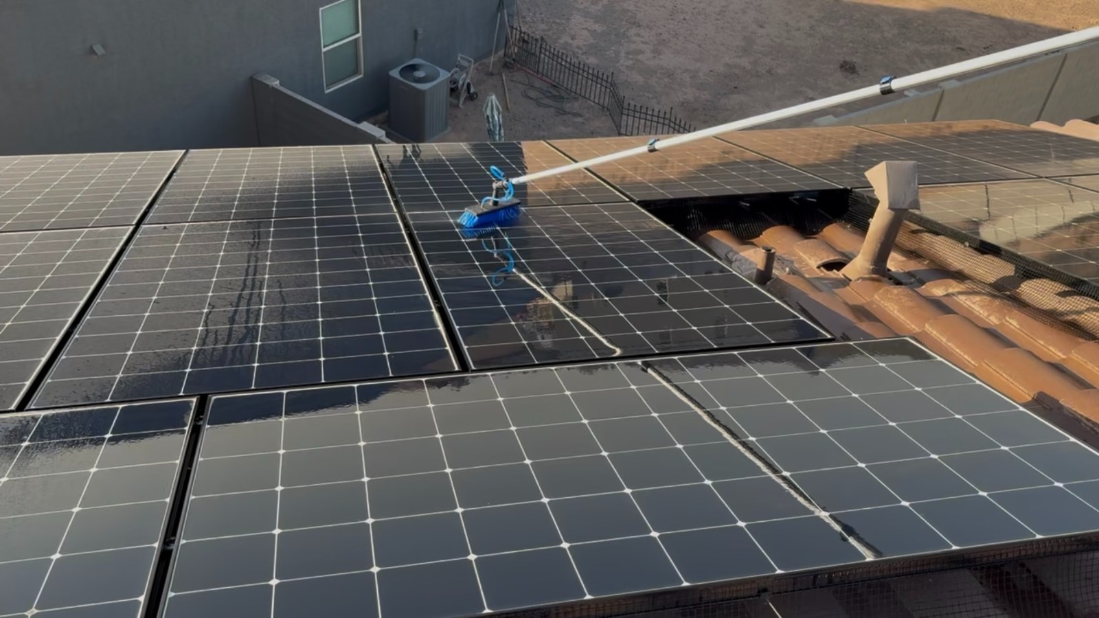 Soft-bristle brush and deionized water on a Florence rooftop array